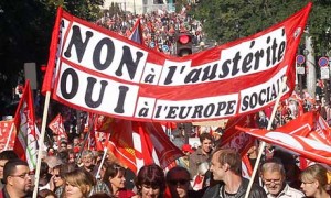 Protesters carry a banner reading 'no to austerity'